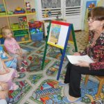 Children and teacher discuss fire safety picture