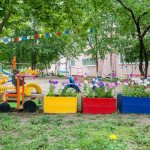 Flowerbed in the shape of a train in kindergarten