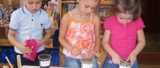 Three children study the properties of sand, earth and clay