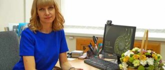 Teacher at the desk at the computer