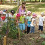 Teacher with children at the site